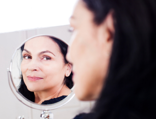 a mature lady smiling with ageing skin